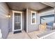 Front porch with gray door and white railings at 13402 E 110Th Way, Commerce City, CO 80022