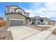 Two-story house front, gray siding, attached garage at 13402 E 110Th Way, Commerce City, CO 80022