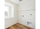 Laundry room with shelving and window at 13402 E 110Th Way, Commerce City, CO 80022