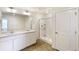 Bright bathroom featuring a double vanity sink and shower with a glass door at 816 Leeward St, Lochbuie, CO 80603