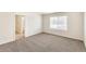 Bedroom boasts neutral walls, carpet flooring, and natural light from the window at 816 Leeward St, Lochbuie, CO 80603