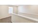 Upstairs hallway with modern railing, neutral walls, and carpeted floor at 816 Leeward St, Lochbuie, CO 80603