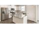 Kitchen featuring granite counters, stainless steel appliances, and white cabinetry at 816 Leeward St, Lochbuie, CO 80603