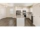 Modern kitchen boasts stainless steel appliances, granite countertops, white cabinetry, and open floor plan at 816 Leeward St, Lochbuie, CO 80603