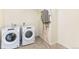 Bright laundry room featuring a washer, dryer and water heater at 816 Leeward St, Lochbuie, CO 80603
