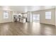 Spacious living area with wood floors, an island in the kitchen, and sliding glass doors at 816 Leeward St, Lochbuie, CO 80603