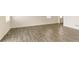 Bright, open-concept living area featuring wood flooring and neutral wall colors at 816 Leeward St, Lochbuie, CO 80603