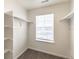 Walk-in closet with window, shelving and hanging rods for optimal storage at 816 Leeward St, Lochbuie, CO 80603