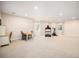 A large carpeted basement area with a dining table and workout equipment at 3406 Quicksilver Rd, Frederick, CO 80516