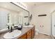 A spacious bathroom featuring double sinks, sleek hardware, and a glass-enclosed shower at 3406 Quicksilver Rd, Frederick, CO 80516
