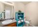 Bright bathroom features a single sink vanity and decorative storage shelves at 3406 Quicksilver Rd, Frederick, CO 80516