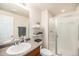 A cozy bathroom featuring a single vanity, and a glass-enclosed shower at 3406 Quicksilver Rd, Frederick, CO 80516