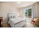 A bedroom with a farmhouse style bed and large window with beautiful view at 3406 Quicksilver Rd, Frederick, CO 80516