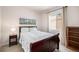 Inviting bedroom with a comfortable bed, soft lighting, and a large window at 3406 Quicksilver Rd, Frederick, CO 80516