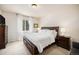A cozy bedroom with a dark wood bedroom set and lots of natural light from the window at 3406 Quicksilver Rd, Frederick, CO 80516
