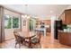 Eat-in kitchen featuring an island, stainless steel appliances, and wood floors at 3406 Quicksilver Rd, Frederick, CO 80516