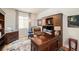 Home office with a large wooden desk, comfortable chair, and natural light at 3406 Quicksilver Rd, Frederick, CO 80516
