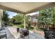 A covered patio featuring a dining table and a view of the backyard at 3406 Quicksilver Rd, Frederick, CO 80516