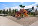 A modern neighborhood playground offers a slide, climbing stairs and lush landscaping at 3406 Quicksilver Rd, Frederick, CO 80516
