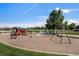 Neighborhood playground offers playset, swings, picnic bench and lush landscaping at 3406 Quicksilver Rd, Frederick, CO 80516