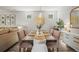Beautiful dining room features natural light and wooden dining table set for six with elegant decor at 10062 Southlawn Cir, Commerce City, CO 80022