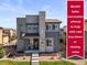 Inviting front exterior showcasing a two-story home with a stone accent wall and landscaped front yard at 10062 Southlawn Cir, Commerce City, CO 80022