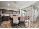 This kitchen features stainless steel appliances, an island with seating, and dark wood cabinets at 10062 Southlawn Cir, Commerce City, CO 80022