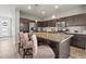 Bright kitchen features stainless steel appliances, a kitchen island with barstool seating, and dark wood cabinets at 10062 Southlawn Cir, Commerce City, CO 80022