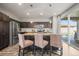 Modern kitchen with stainless steel appliances, a kitchen island with seating, and sliding glass doors to the patio at 10062 Southlawn Cir, Commerce City, CO 80022