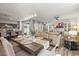 Open-concept living space with a dining table, a sofa, and a TV for seamless entertaining at 10062 Southlawn Cir, Commerce City, CO 80022