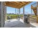 Cozy back porch area with outdoor furniture and a grill, perfect for entertaining at 5134 Queen Ct, Arvada, CO 80002