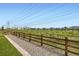 Scenic backyard with a walking path, wooden fence, and neighborhood views in the distance at 5134 Queen Ct, Arvada, CO 80002
