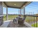 Comfortable balcony with outdoor seating overlooking a view of green space and the neighborhood at 5134 Queen Ct, Arvada, CO 80002