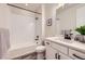 Modern bathroom with white cabinets, black hardware and a shower-tub combo at 5134 Queen Ct, Arvada, CO 80002