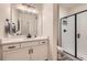 Modern bathroom with a white vanity, matte black hardware, and a glass-enclosed shower at 5134 Queen Ct, Arvada, CO 80002