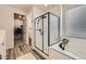 A modern bathroom featuring a glass shower, soaking tub, and sleek black hardware at 5134 Queen Ct, Arvada, CO 80002