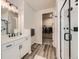 Modern bathroom features include a glass shower and easy access to the walk-in closet at 5134 Queen Ct, Arvada, CO 80002