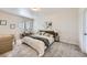 A cozy bedroom with neutral walls, gray carpet and an ensuite bathroom at 5134 Queen Ct, Arvada, CO 80002