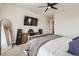 The cozy bedroom features a large TV, speakers, a mirror and an ensuite bathroom at 5134 Queen Ct, Arvada, CO 80002