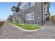 Exterior of the home showing the backyard with a retaining wall and access to the upper level at 5134 Queen Ct, Arvada, CO 80002