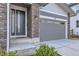 Attractive home exterior featuring stone accents, gray siding, and an attached garage at 5134 Queen Ct, Arvada, CO 80002