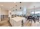 Open concept kitchen with a large island, dining area and living space at 5134 Queen Ct, Arvada, CO 80002