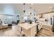 Open kitchen and living area with a large island and modern appliances at 5134 Queen Ct, Arvada, CO 80002
