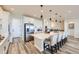Bright kitchen with white cabinets, stainless steel appliances, and bar stool seating at 5134 Queen Ct, Arvada, CO 80002