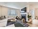 Bright living room with fireplace, large windows, and stylish decor at 5134 Queen Ct, Arvada, CO 80002