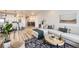 Open-concept living space featuring modern furnishings and hardwood flooring at 5134 Queen Ct, Arvada, CO 80002