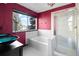 A luxury bathroom featuring red walls, modern fixtures, a shower and a tub at 96 S Lindsey St, Castle Rock, CO 80104