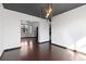 Dining room with dark hardwood floors, modern light fixture, and an open floor plan at 96 S Lindsey St, Castle Rock, CO 80104