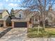 Inviting two-story home with brick accents, a lush front lawn, and an attached two-car garage for convenience at 96 S Lindsey St, Castle Rock, CO 80104