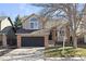 Charming home with brick and neutral siding, black garage door, and landscaping at 96 S Lindsey St, Castle Rock, CO 80104